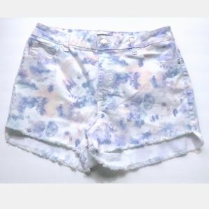 White cutoff jean shorts in painted blues/pinks